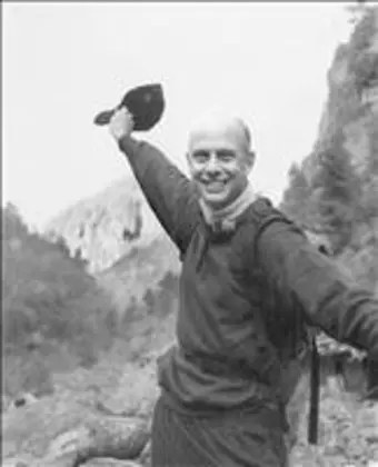 Peter Cundill, hiking, waving his cap to the camera